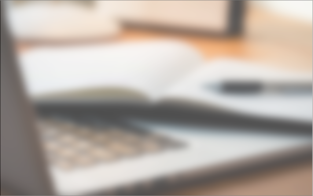 Laptop, notepad and pen on desk
